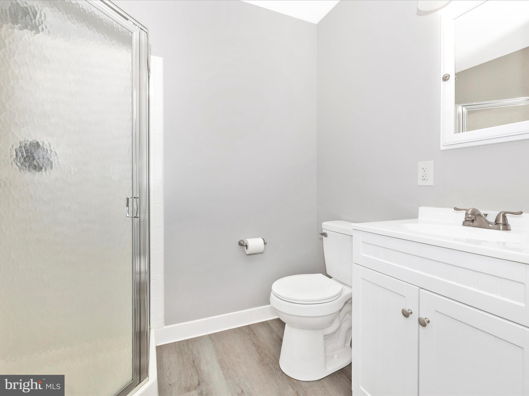 102 Mercer Court, Unit 22 1A Frederick, MD 21701 - Photo 29 of 56 a white toilet sitting next to a bathroom sink