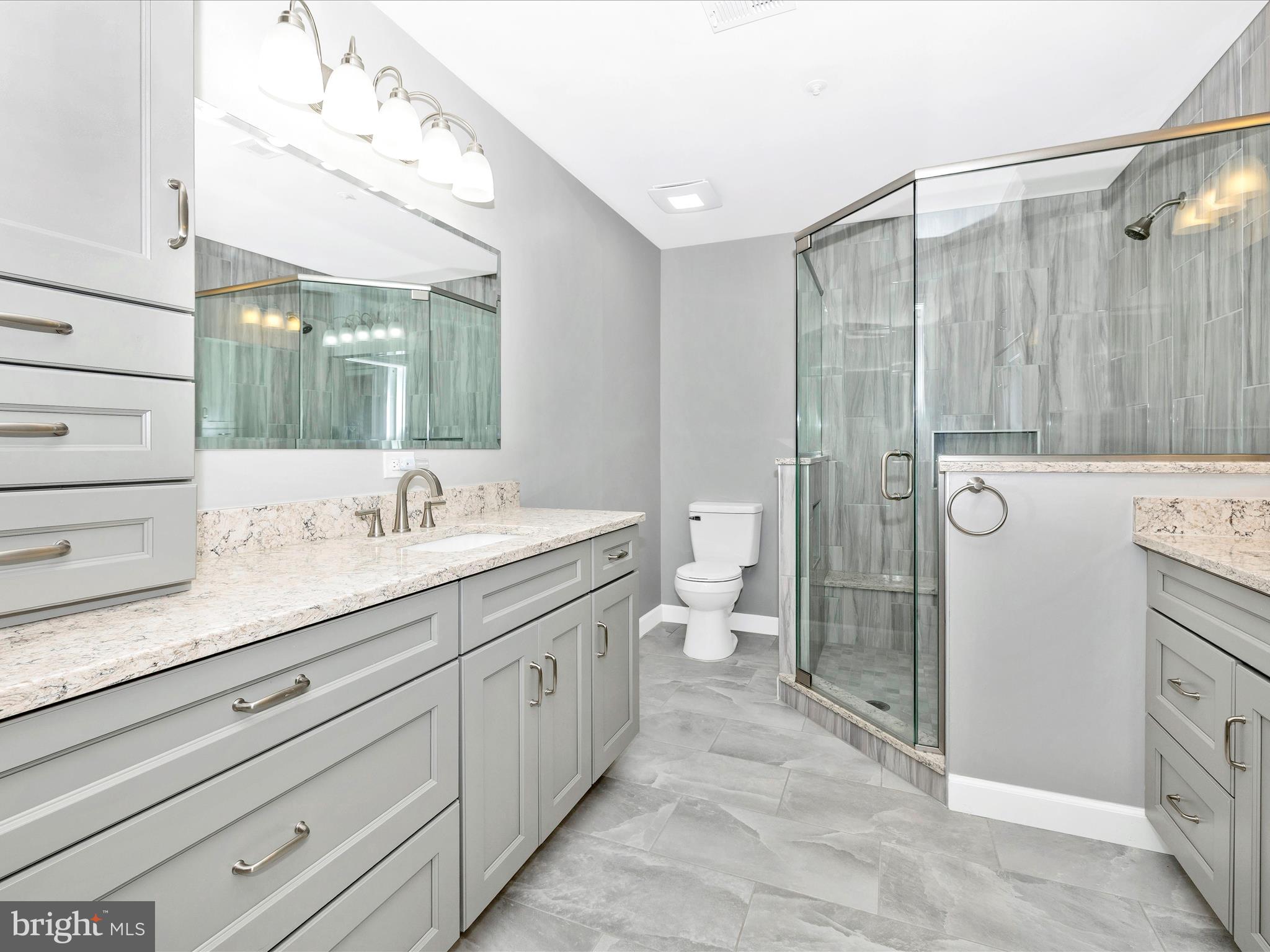 102 Mercer Court, Unit 22 1A Frederick, MD 21701 - Photo 36 of 56 a spacious bathroom with a double vanity sink mirror and shower