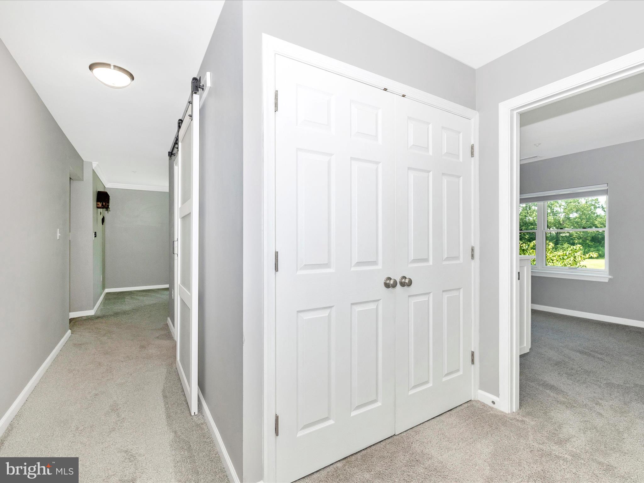 102 Mercer Court, Unit 22 1A Frederick, MD 21701 - Photo 39 of 56 a view of a hallway with wooden floor and closet area