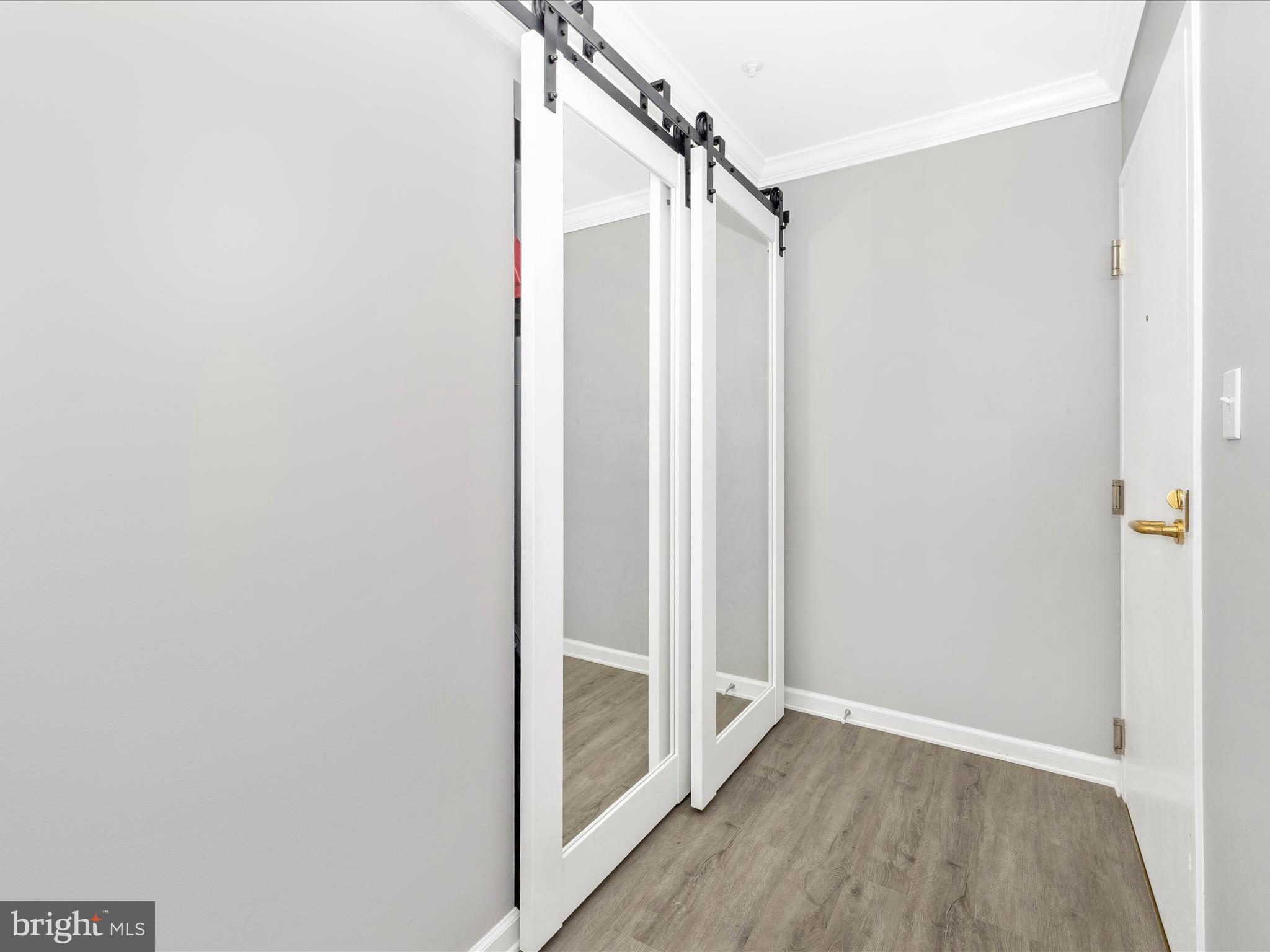 102 Mercer Court, Unit 22 1A Frederick, MD 21701 - Photo 43 of 56 a view of a walk in closet with wooden floor