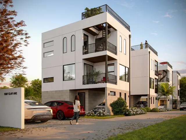 a front view of a building with cars parked