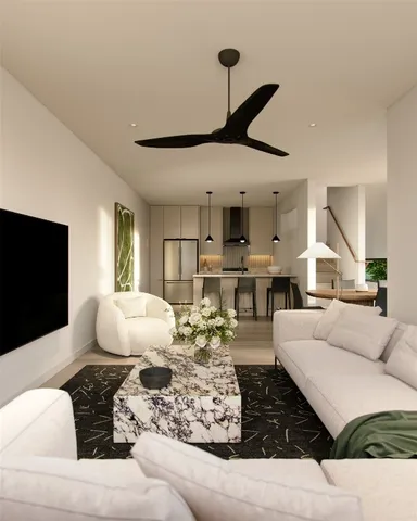 a living room with furniture and wooden floor