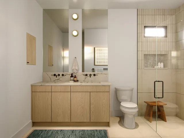 a spacious bathroom with a toilet sink and mirror