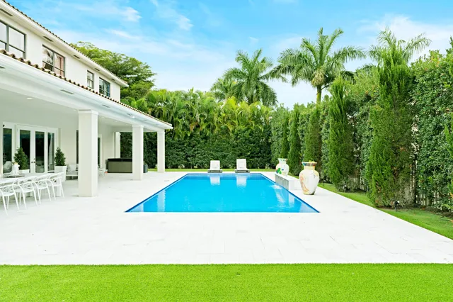 a swimming pool with outdoor seating and yard