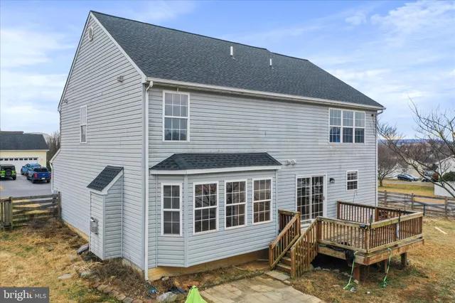 a view of a house with a wooden deck