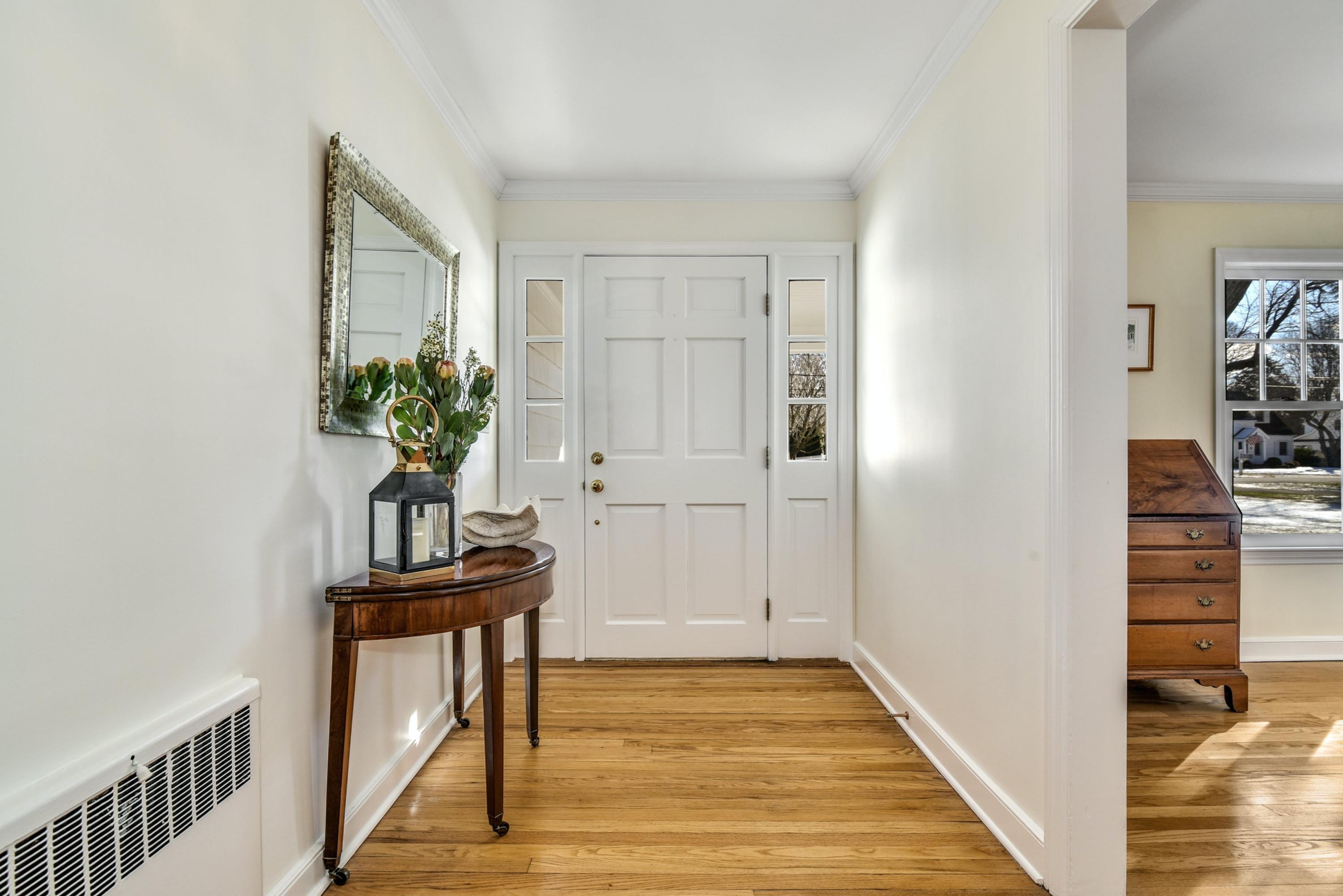 11 Sunset Road Darien, CT 06820 - Photo 3 of 38 a view of a hallway with wooden floor and furniture