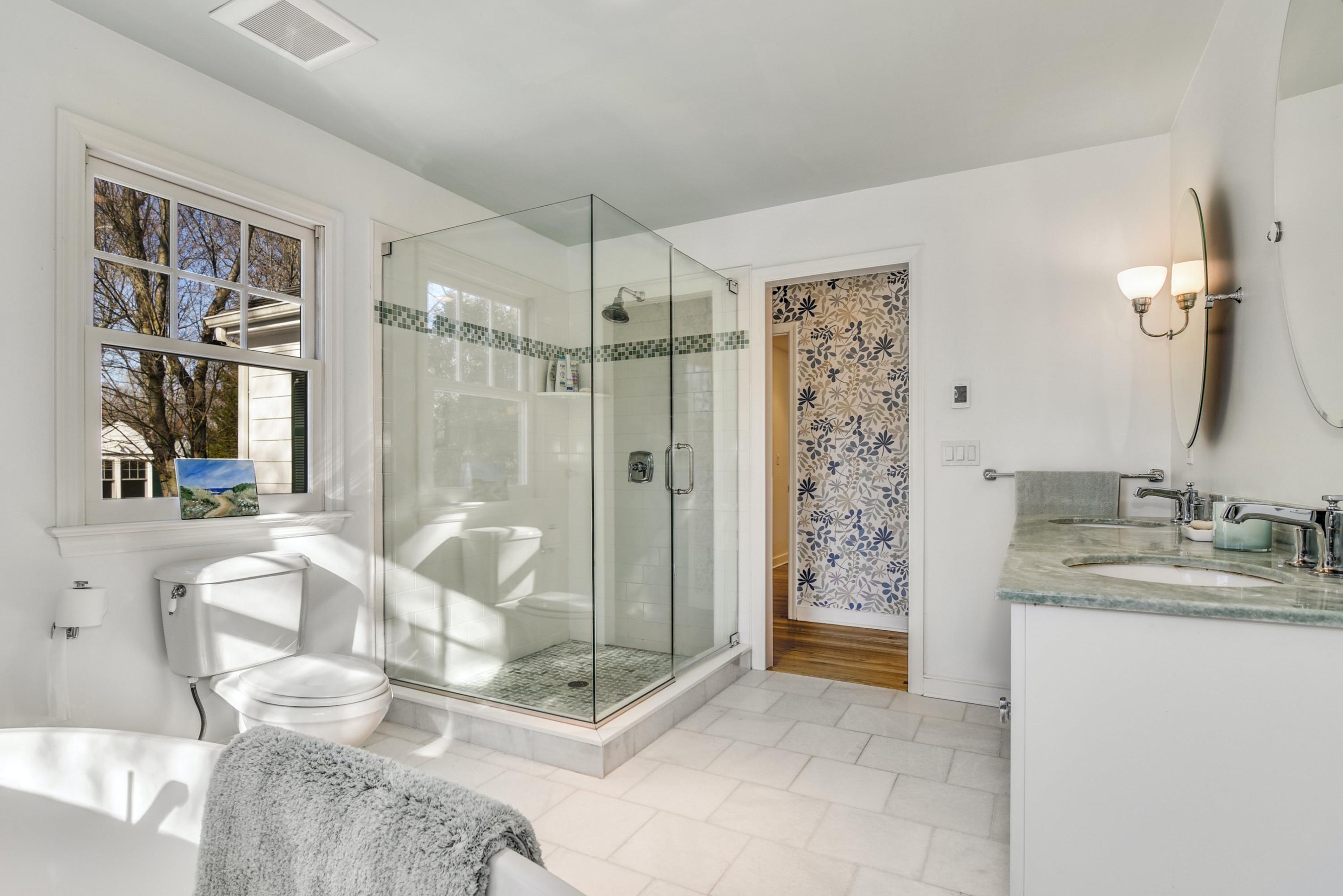 11 Sunset Road Darien, CT 06820 - Photo 25 of 38 a bathroom with a granite countertop sink a mirror and shower