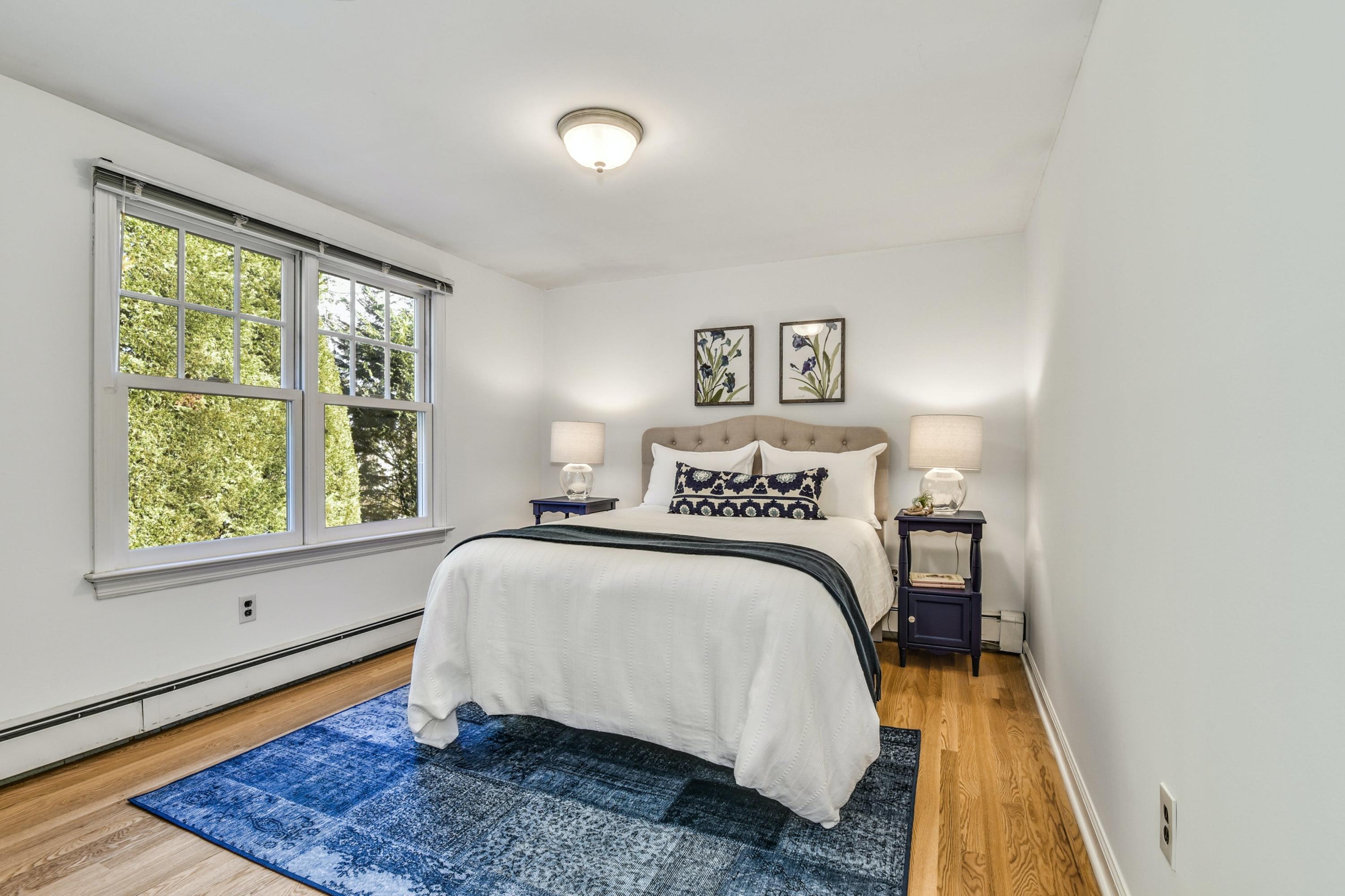 11 Sunset Road Darien, CT 06820 - Photo 27 of 38 a bedroom with a bed and wooden floor