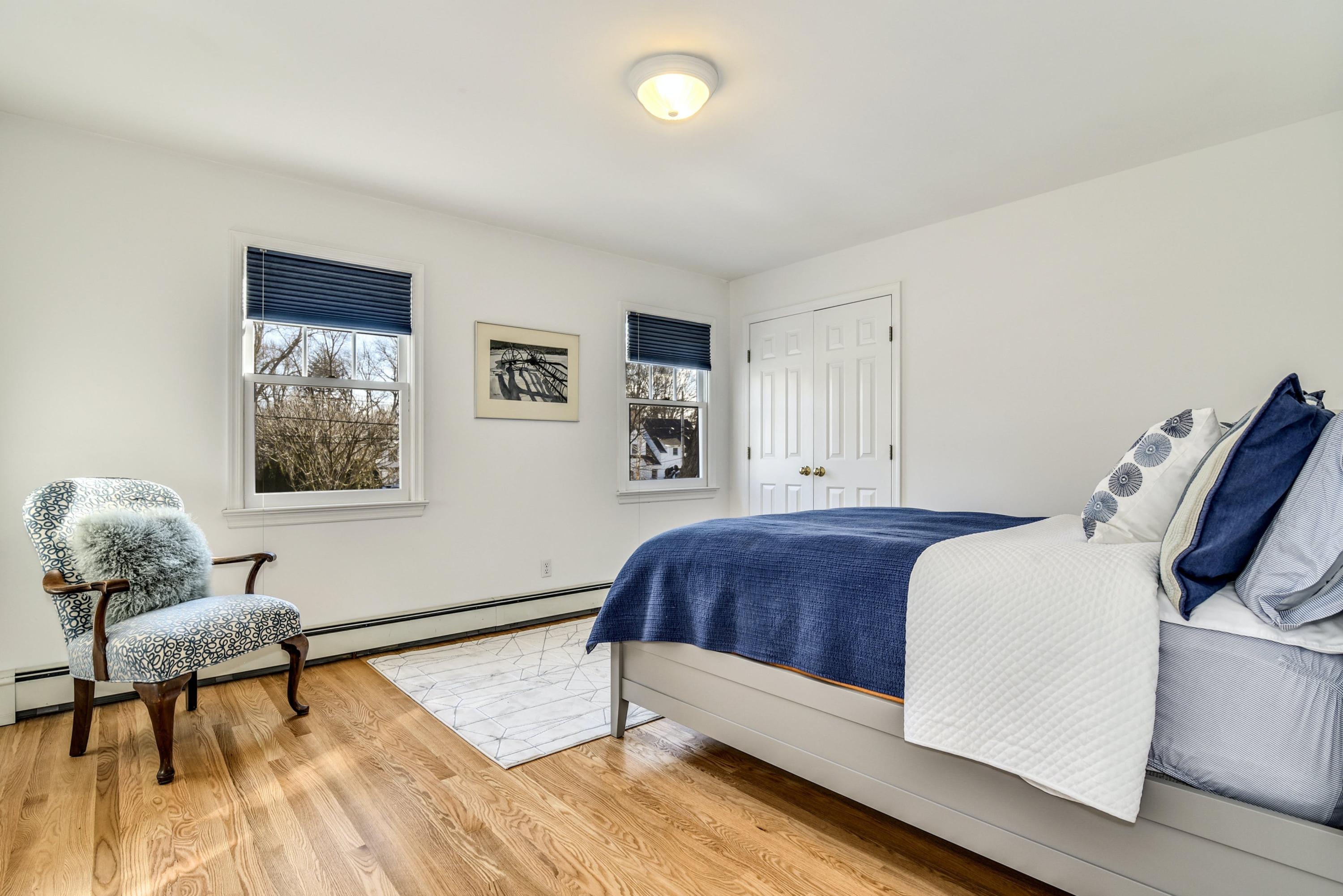 11 Sunset Road Darien, CT 06820 - Photo 28 of 38 a bedroom with a bed and wooden floor