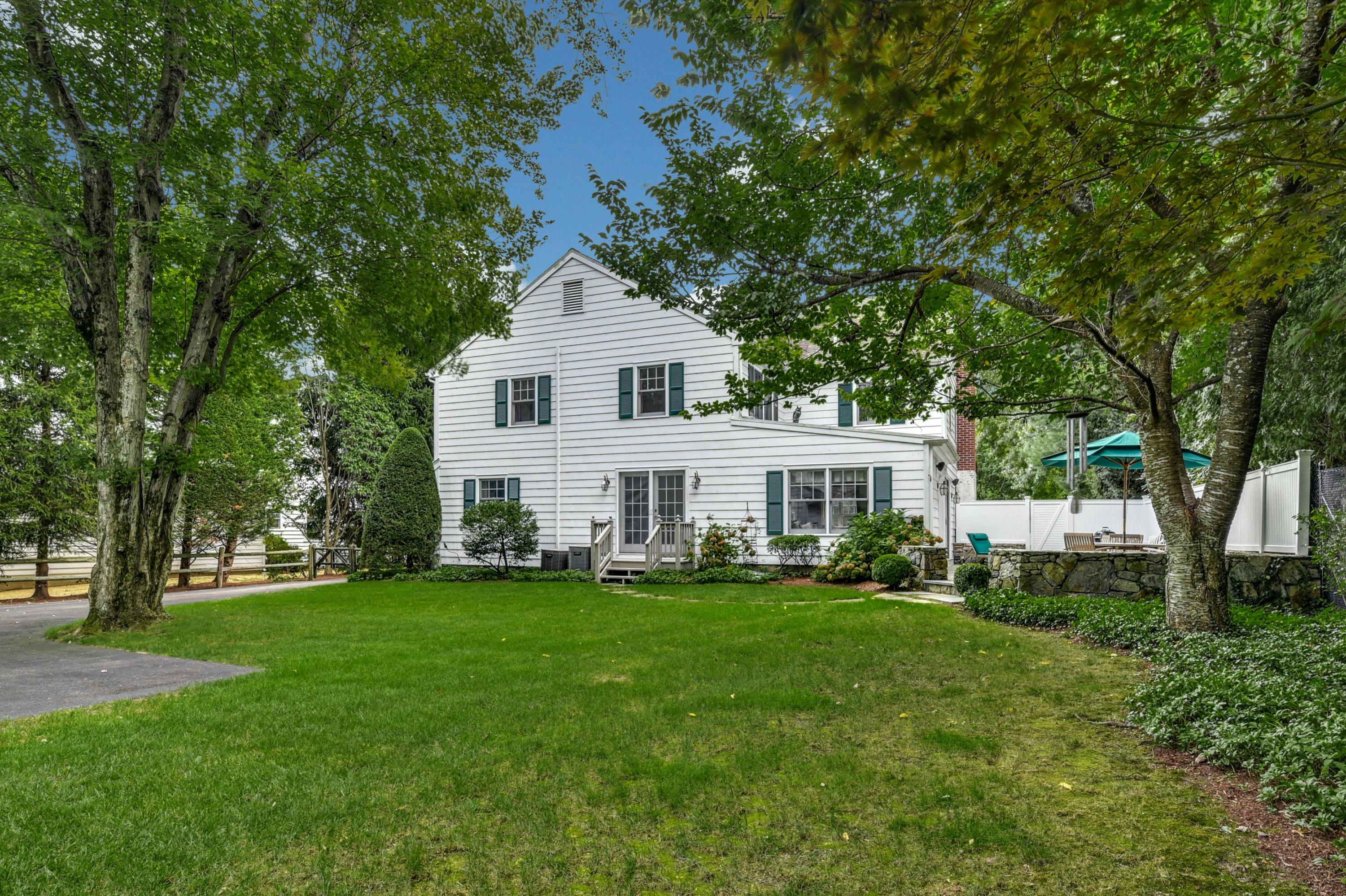 11 Sunset Road Darien, CT 06820 - Photo 33 of 38 a front view of a house with a garden and trees