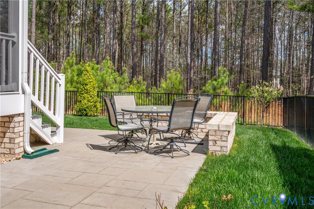 9419 Widthby Road Chesterfield, VA 23832 - Photo 5 of 23 a view of a chairs and table in patio with wooden fence