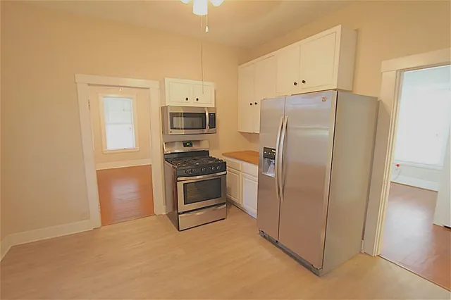 a kitchen with stainless steel appliances a refrigerator and a stove
