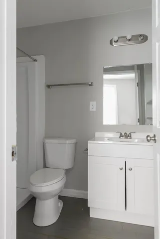 a bathroom with a toilet sink and mirror