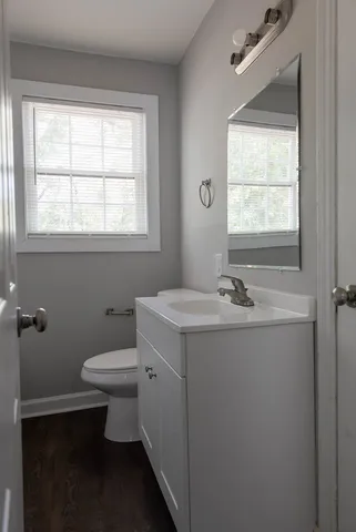 a bathroom with a sink toilet and window