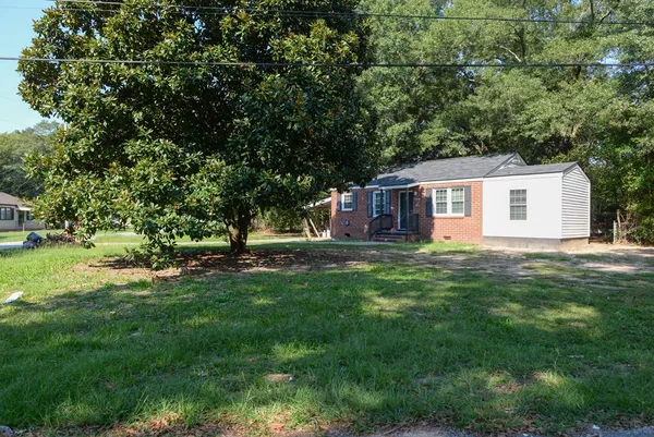 a front view of a house with a garden