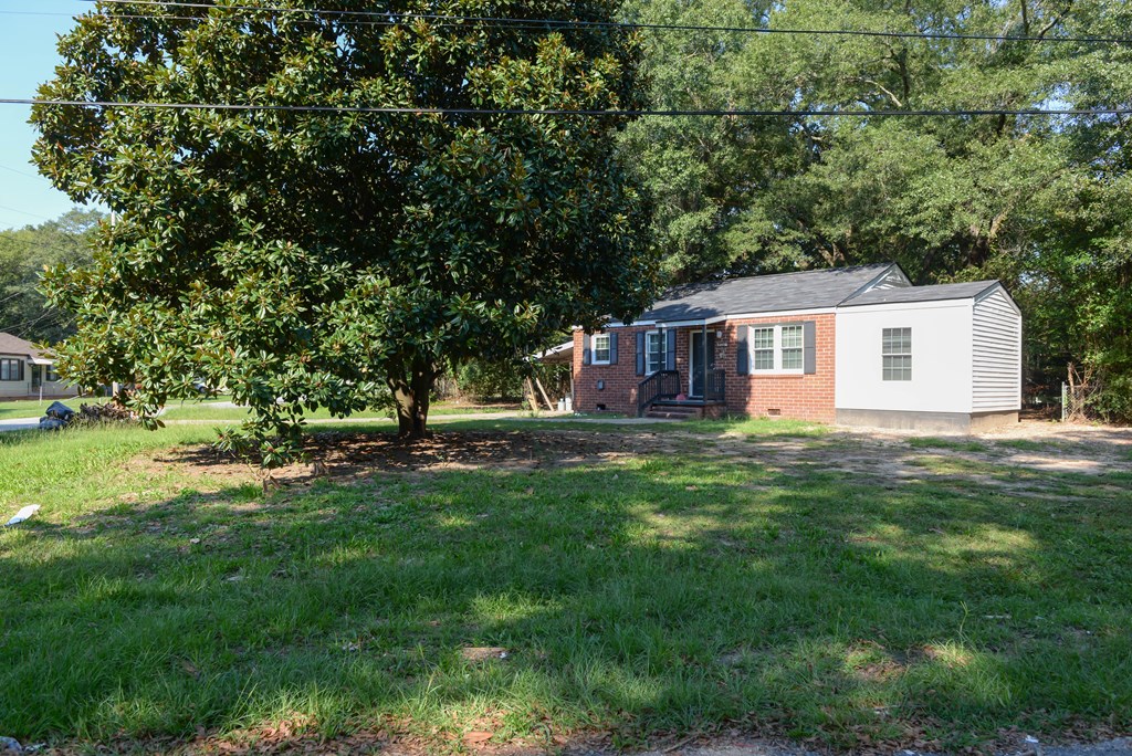 3221 Walker Street Columbus, GA 31903 - Photo 2 of 18 a front view of a house with a garden