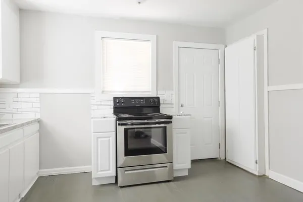 a kitchen with a stove and a microwave