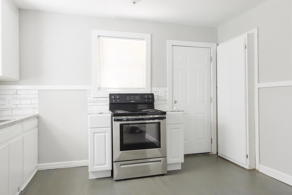 3221 Walker Street Columbus, GA 31903 - Photo 4 of 18 a kitchen with a stove and a microwave