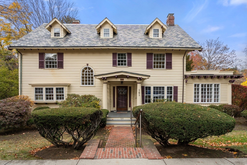 a front view of a house with garden