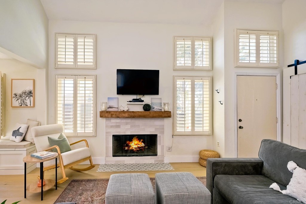 821 Windcrest Drive Carlsbad, CA 92011 - Photo 12 of 53 a living room with furniture a flat screen tv and a fireplace