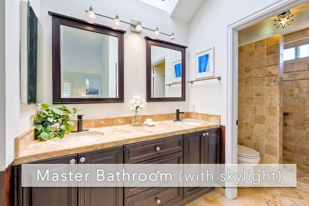 821 Windcrest Drive Carlsbad, CA 92011 - Photo 27 of 53 a view of a bathroom sink mirror and vanity