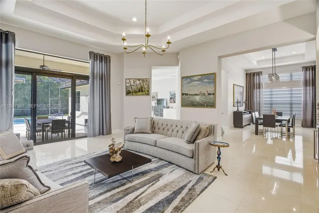 a kitchen with stainless steel appliances kitchen island granite countertop a refrigerator and a sink