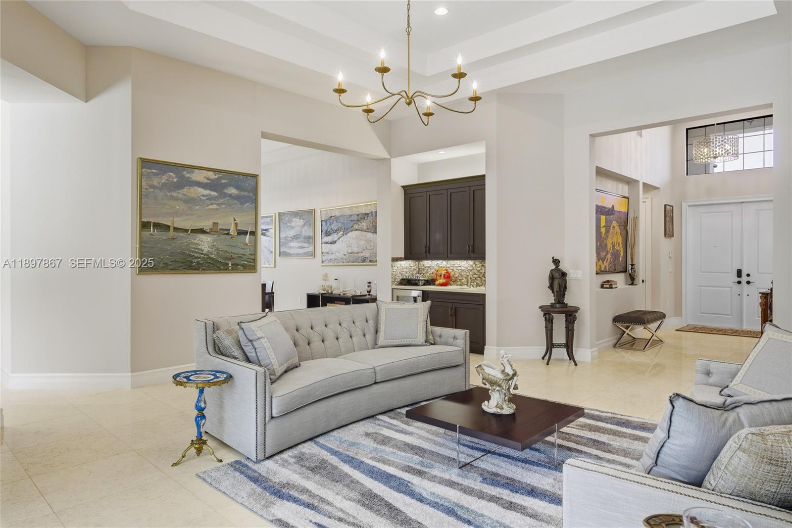 9772 Rennes Lane Delray Beach, FL 33446 - Photo 12 of 59 a living room with furniture a table and a chandelier
