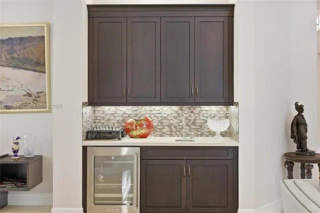 a view of a backyard with table and chairs under an umbrella