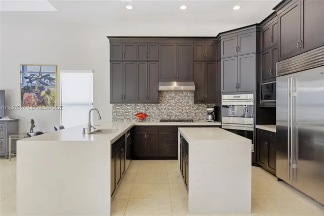 a view of a patio with table and chairs under an umbrella