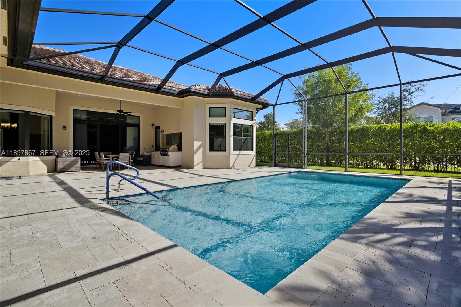 9772 Rennes Lane Delray Beach, FL 33446 - Photo 25 of 59 a view of a backyard with table and chairs under an umbrella