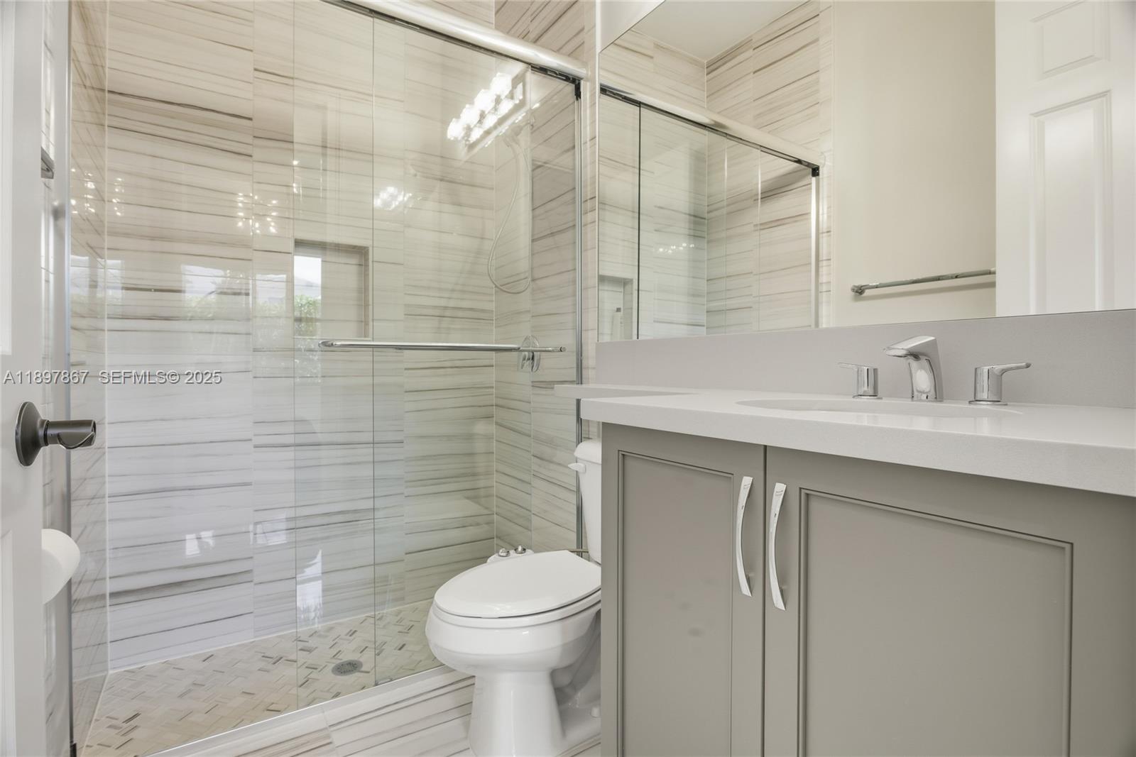 9772 Rennes Lane Delray Beach, FL 33446 - Photo 34 of 59 a bathroom with a sink a toilet and shower