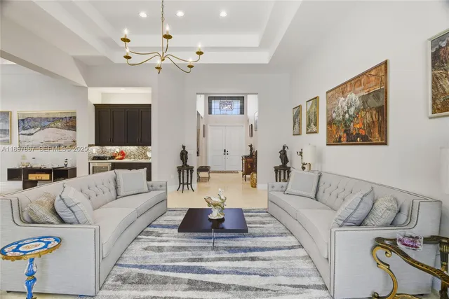 a living room with furniture and kitchen view