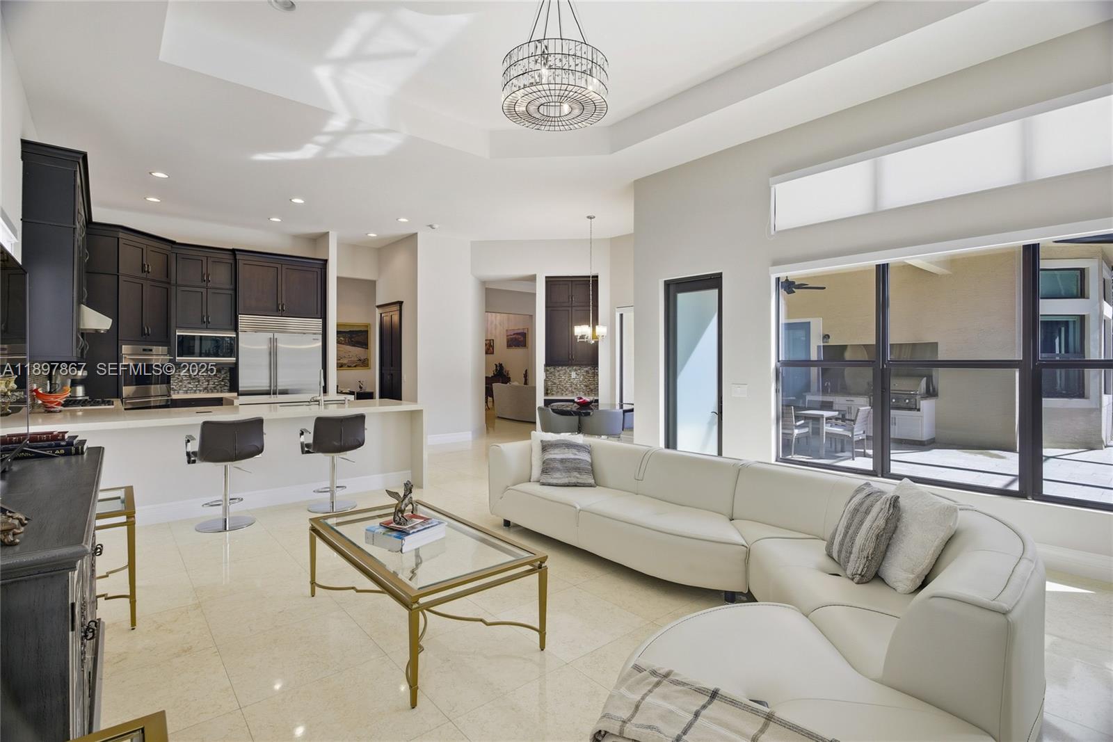 9772 Rennes Lane Delray Beach, FL 33446 - Photo 7 of 59 a living room with furniture and kitchen view