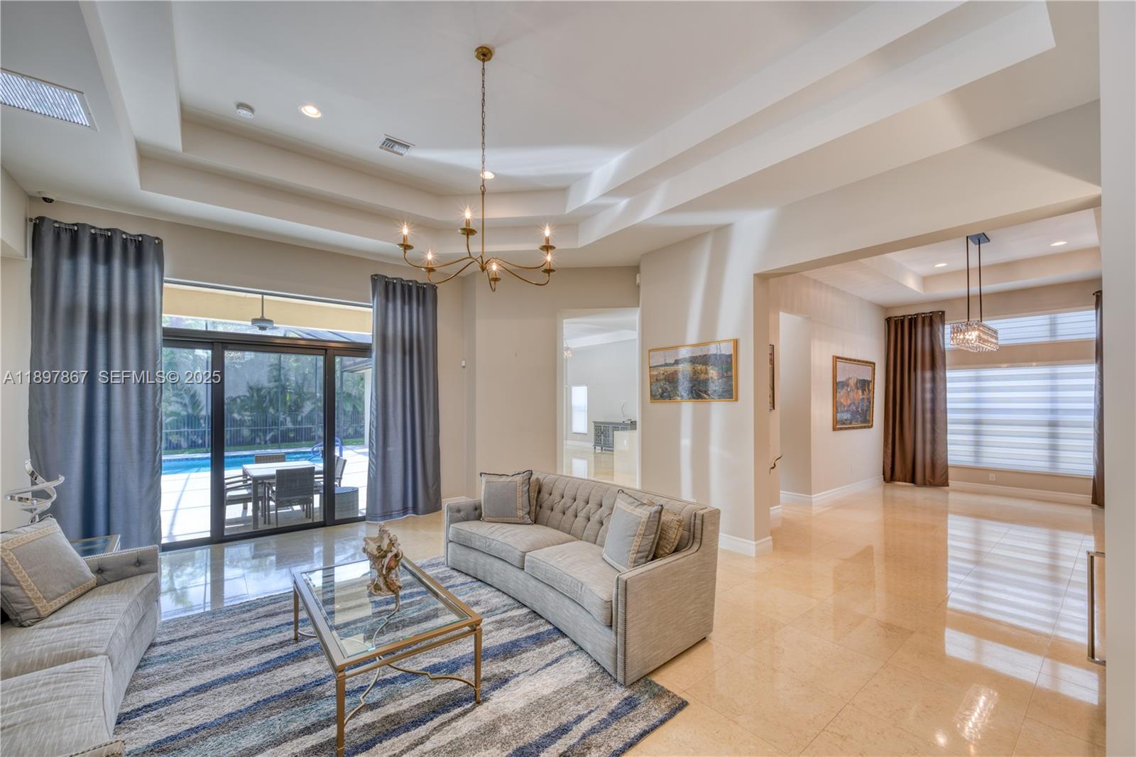 9772 Rennes Lane Delray Beach, FL 33446 - Photo 10 of 59 a living room with furniture and a chandelier