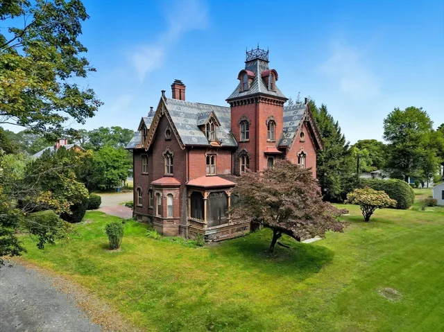 a front view of a house with a yard table and chairs
