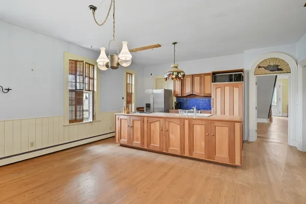 a view of a kitchen with cabinet and a chandelier