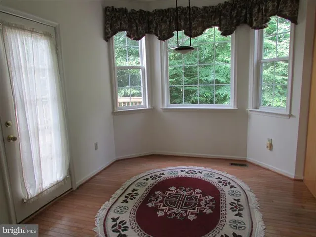 an outdoor space with view of a garden