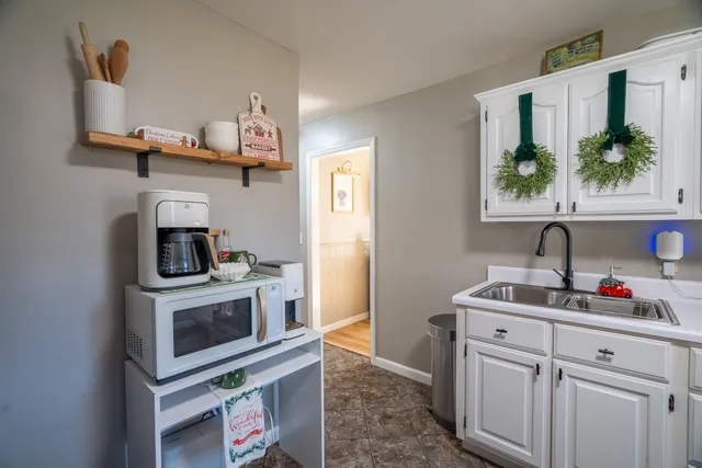 a kitchen with stainless steel appliances a stove a sink and a microwave