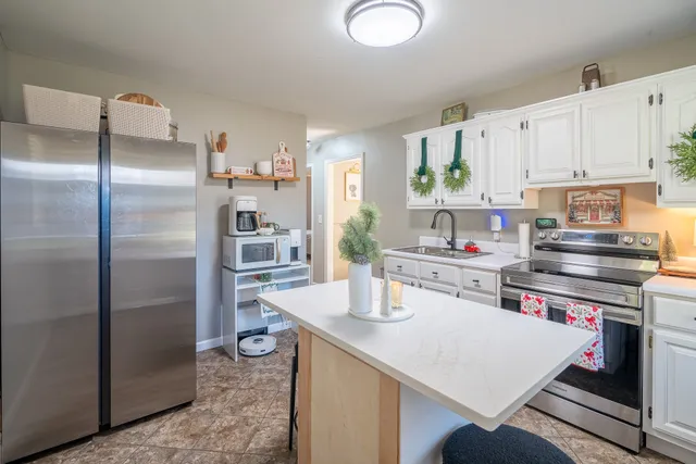 a kitchen with a refrigerator and a sink