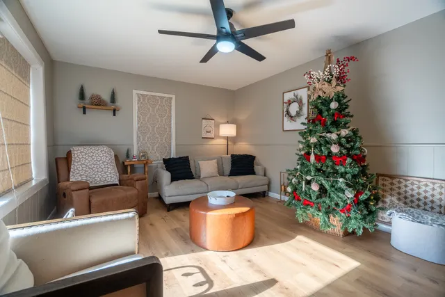 a living room with furniture and a potted plant
