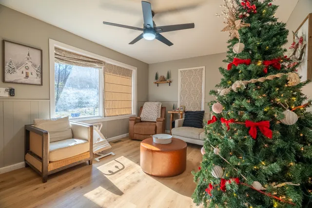 a living room with furniture and flowers