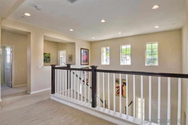 a view of hallway with a large window and stairs