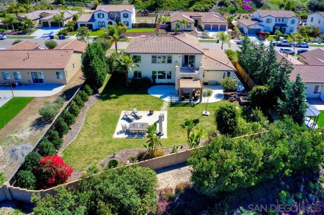 an aerial view of a houses with yard