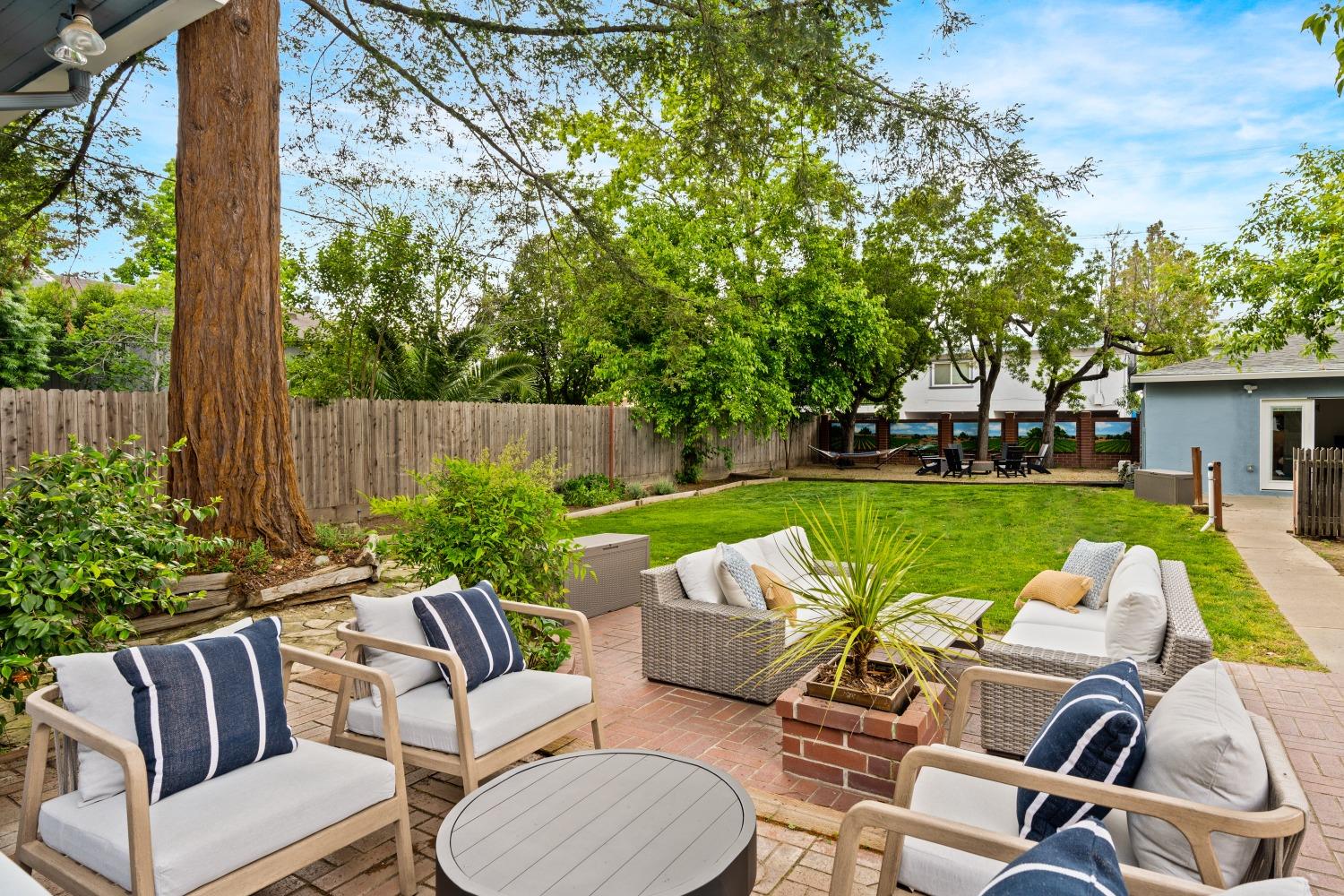 333 West Locust Street Lodi, CA 95240 - Photo 12 of 32 a view of a patio with couches chairs potted plants and a big yard