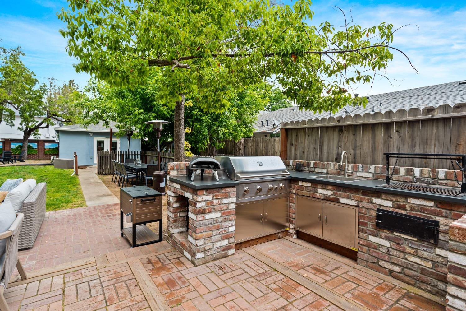 333 West Locust Street Lodi, CA 95240 - Photo 14 of 32 a view of a patio with table and chairs next to a yard