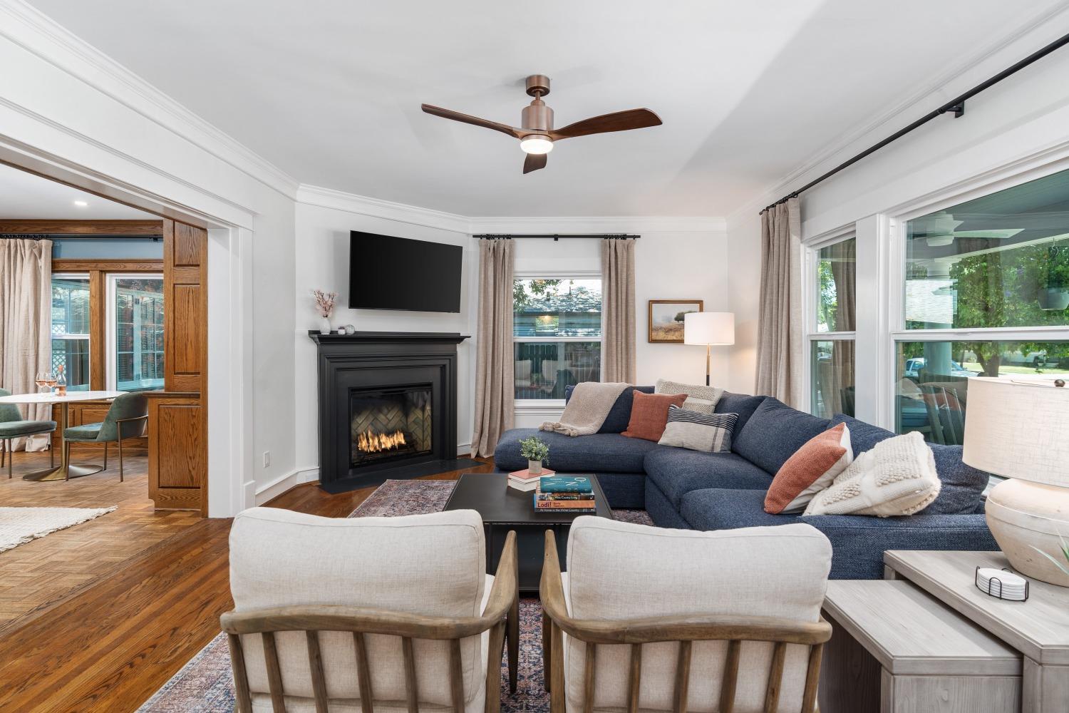 333 West Locust Street Lodi, CA 95240 - Photo 16 of 32 a living room with furniture a flat screen tv and a fireplace