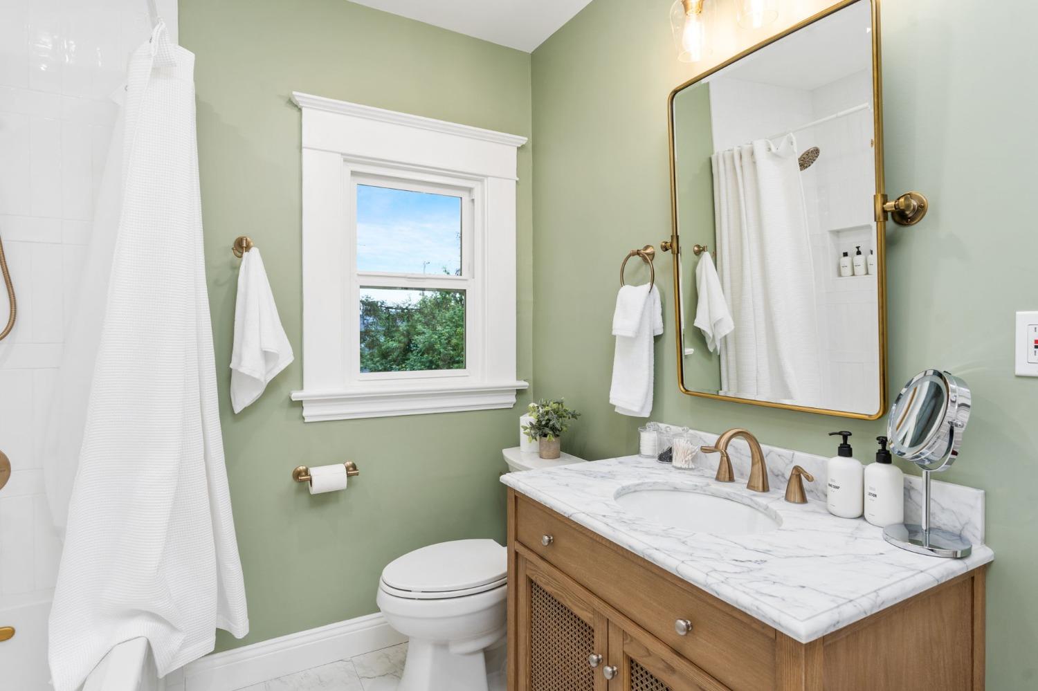 333 West Locust Street Lodi, CA 95240 - Photo 21 of 32 a bathroom with a granite countertop sink and a mirror