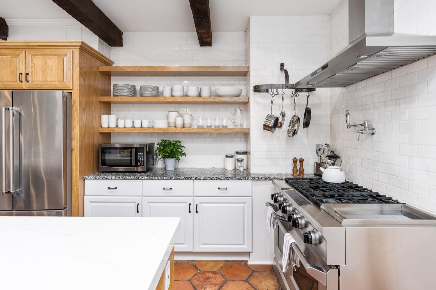 333 West Locust Street Lodi, CA 95240 - Photo 7 of 32 a kitchen with stainless steel appliances a stove a sink and a refrigerator