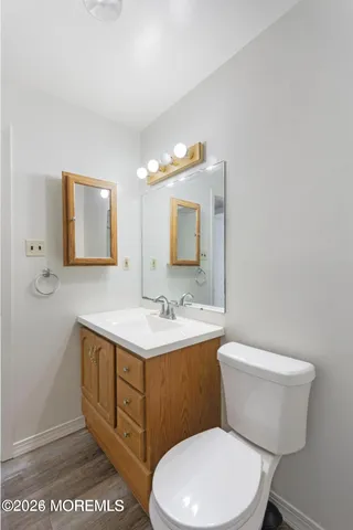 a bathroom with a toilet a sink and mirror
