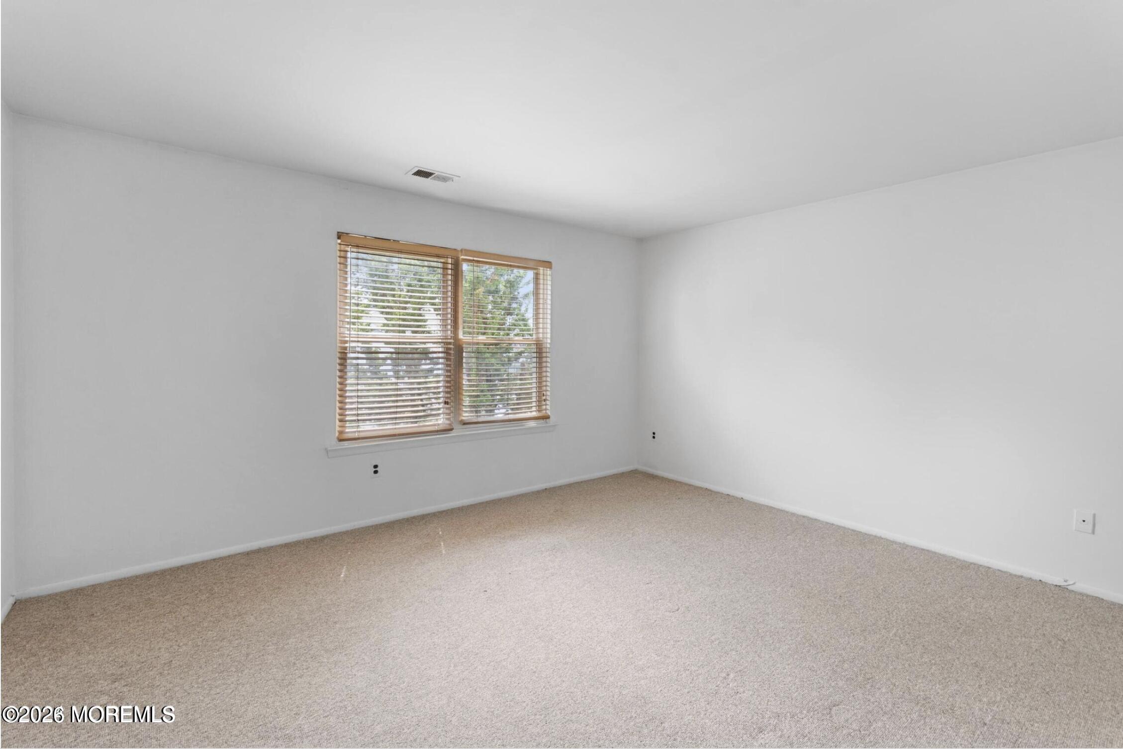 1606 Main Street, Unit R209 Lake Como, NJ 07719 - Photo 21 of 26 an empty room with windows